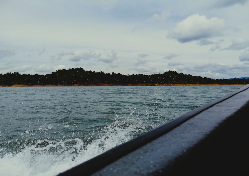 a body of water with trees in the background