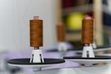 a spool of thread sitting on top of a white plate
