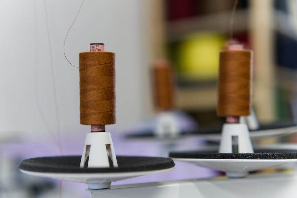 a spool of thread sitting on top of a white plate