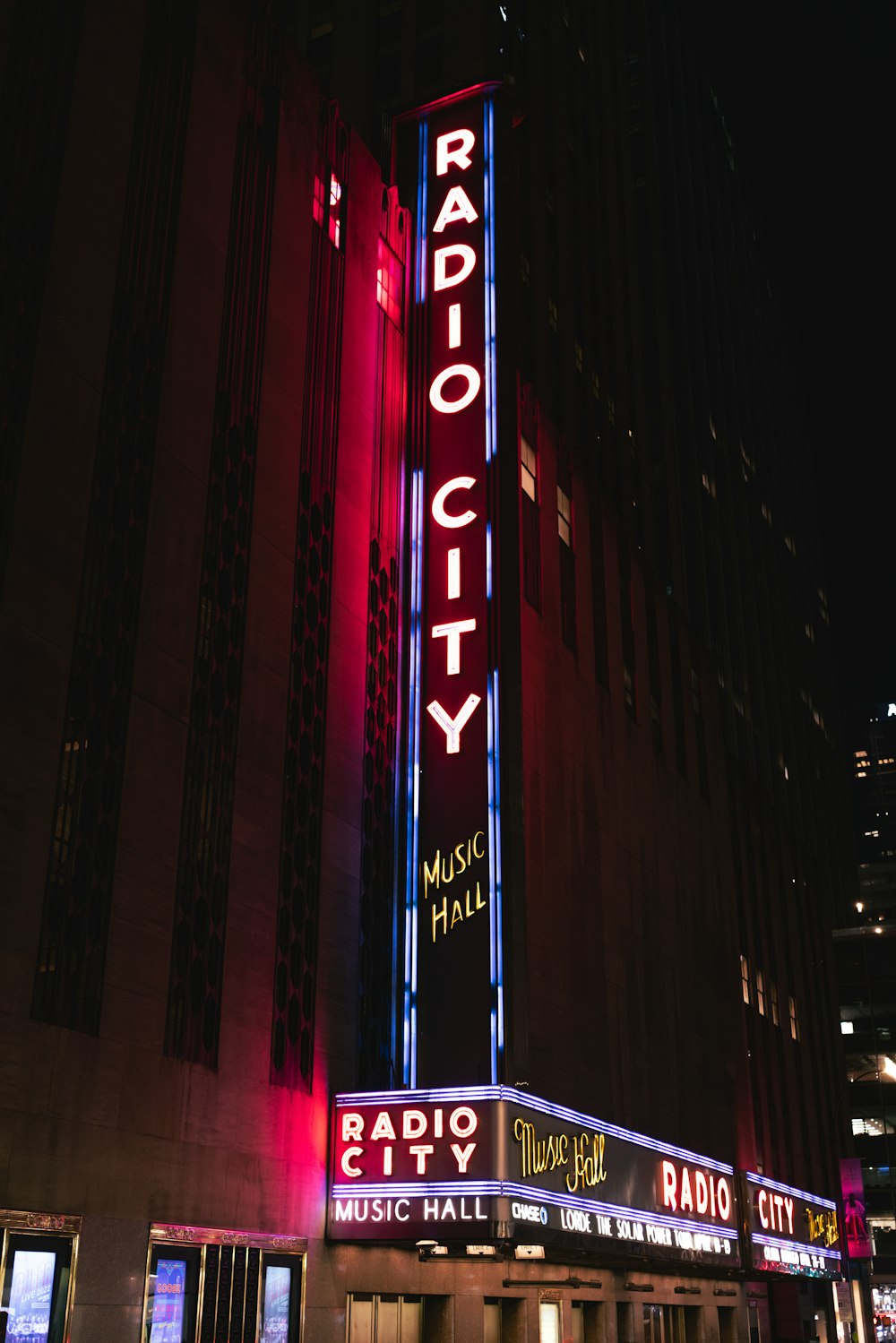 the radio city music hall is lit up at night