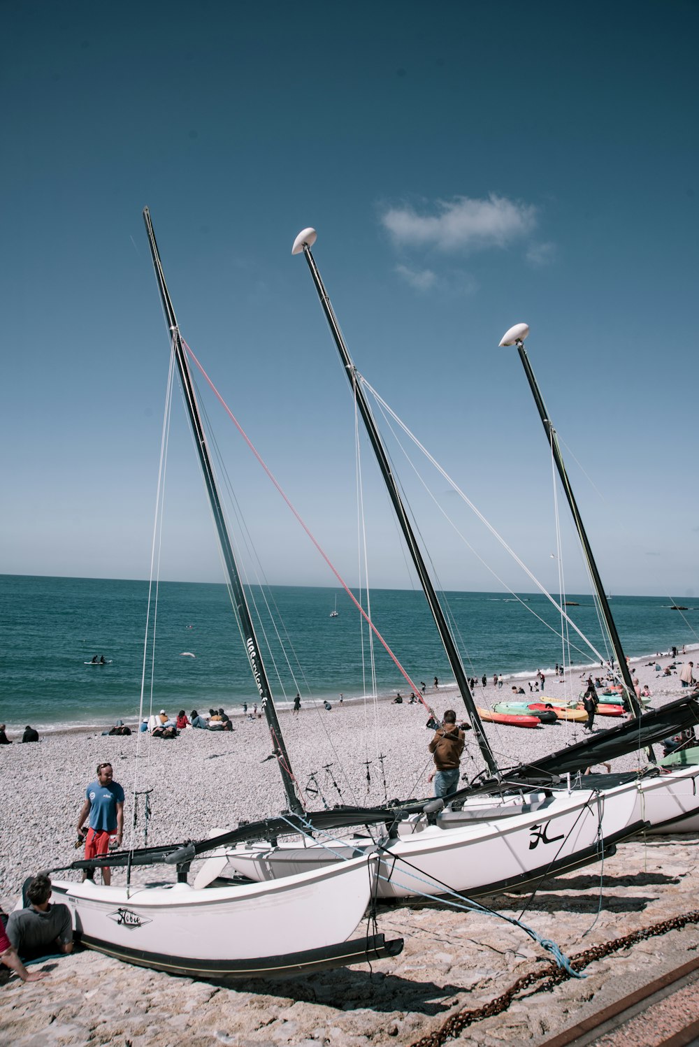 a couple of sail boats sitting on top of a beach