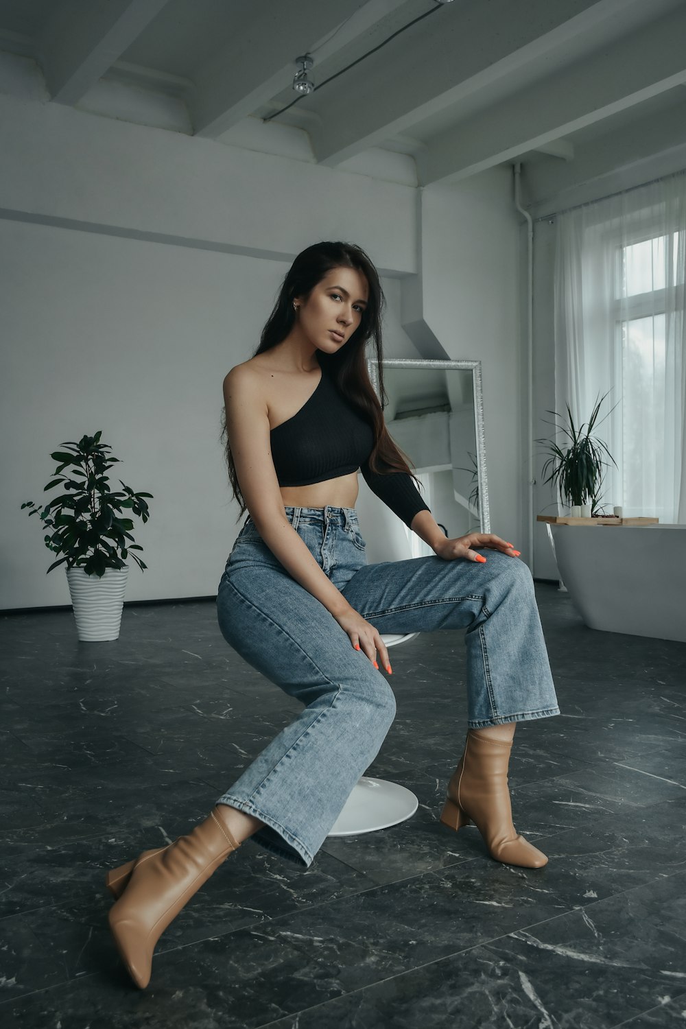 a woman sitting on a stool in a room