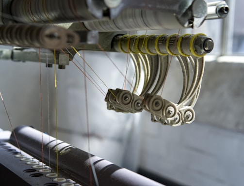 a close up of a machine working on a piece of fabric