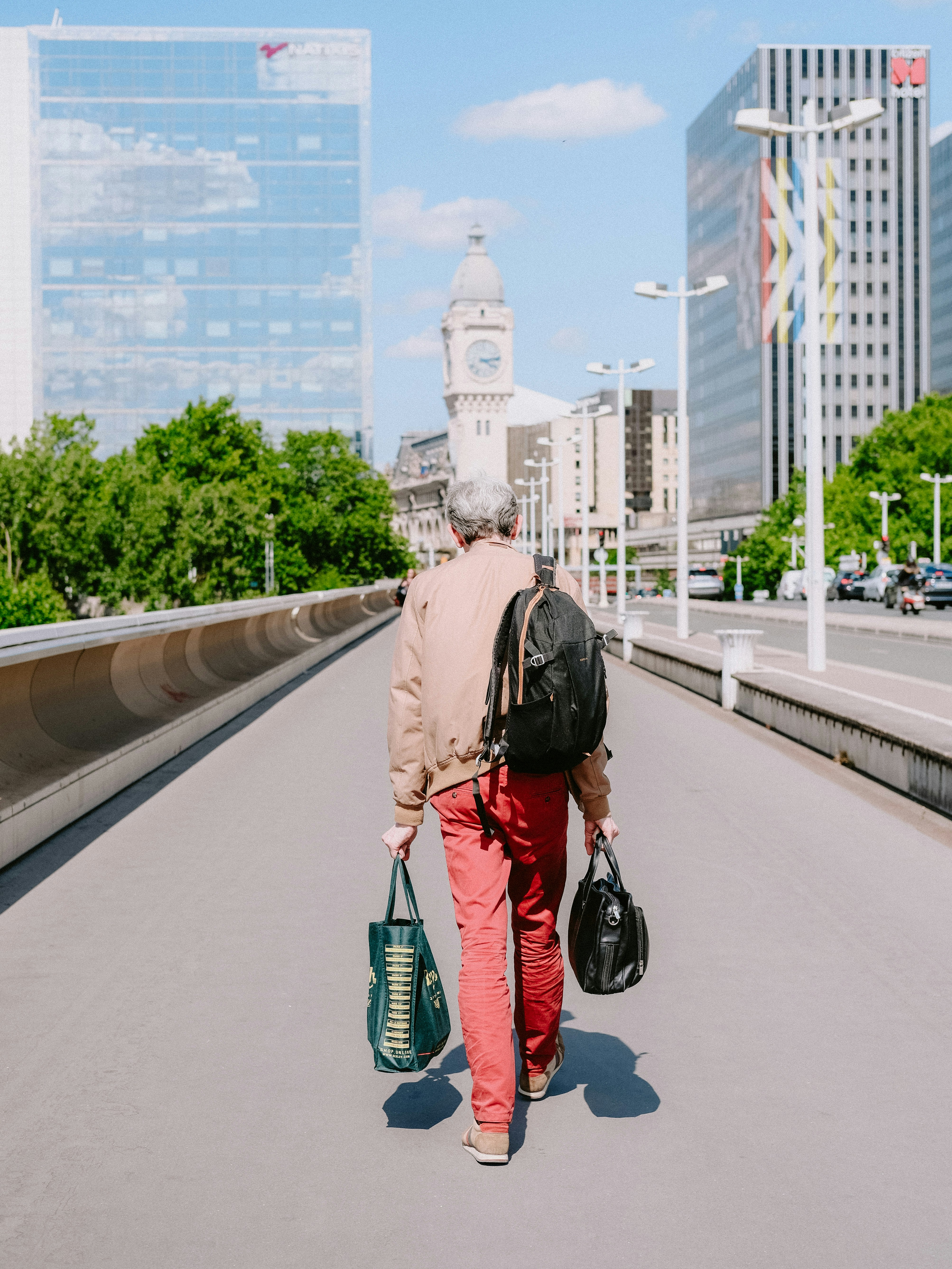 A traveler preparing for a bus trip with ticket and backpack