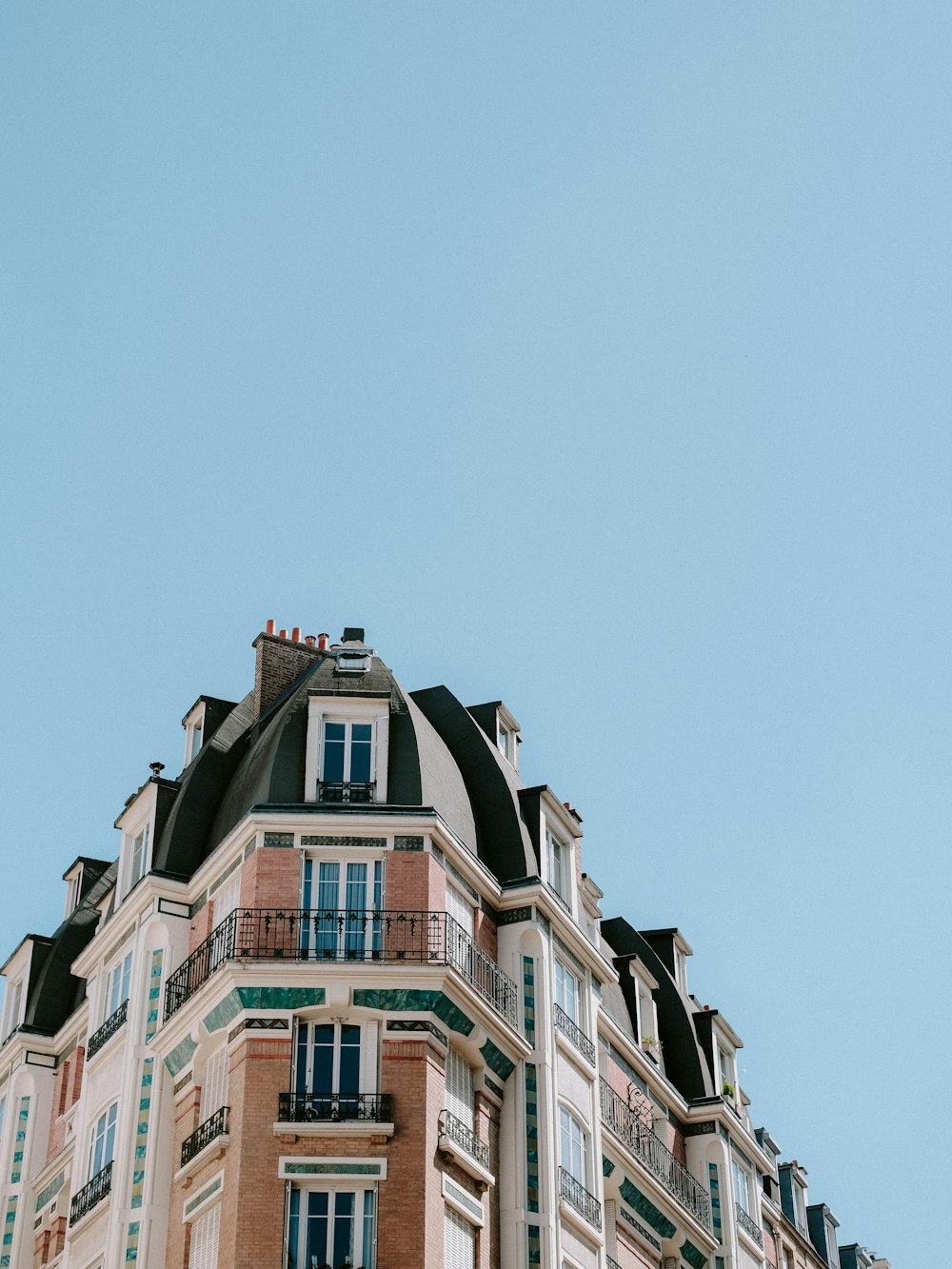 a tall building with balconies on top of it