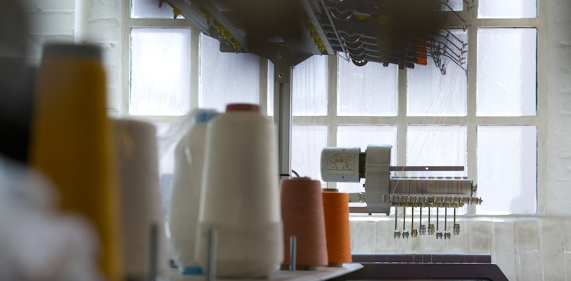 a kitchen counter with a bunch of spools of thread on it