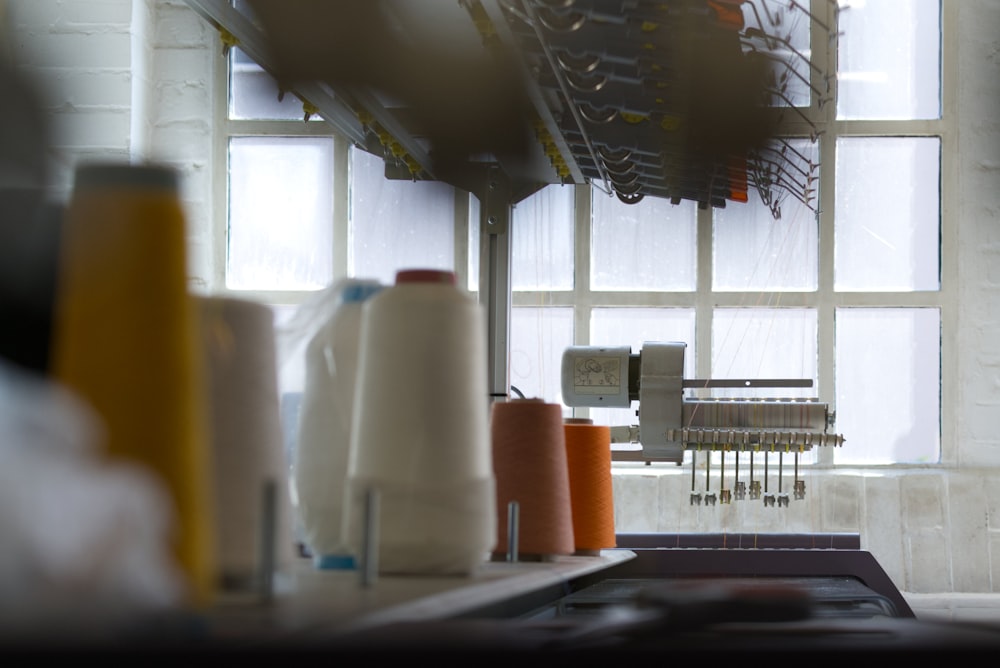 a kitchen counter with a bunch of spools of thread on it