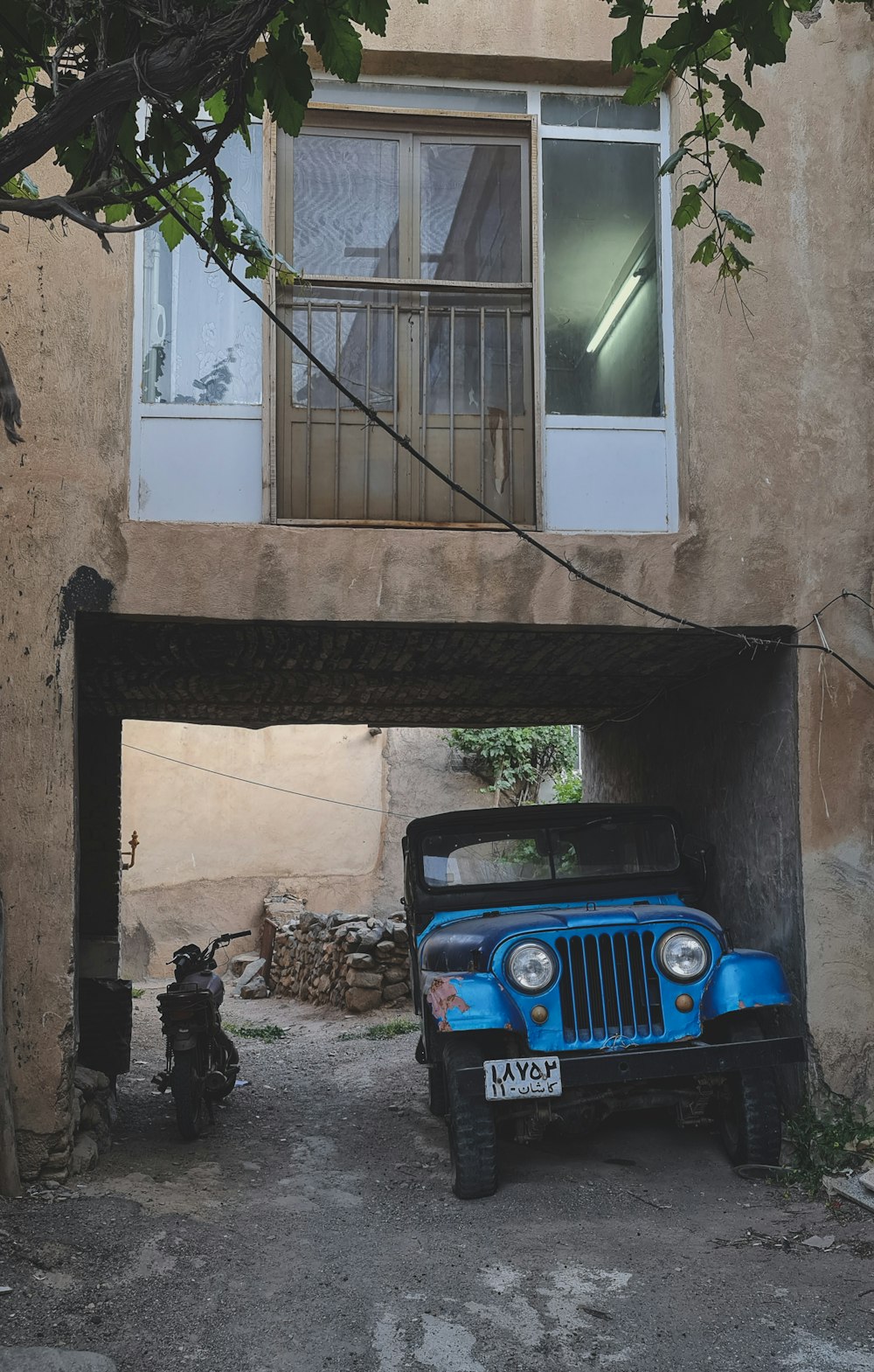 a blue jeep parked in front of a building