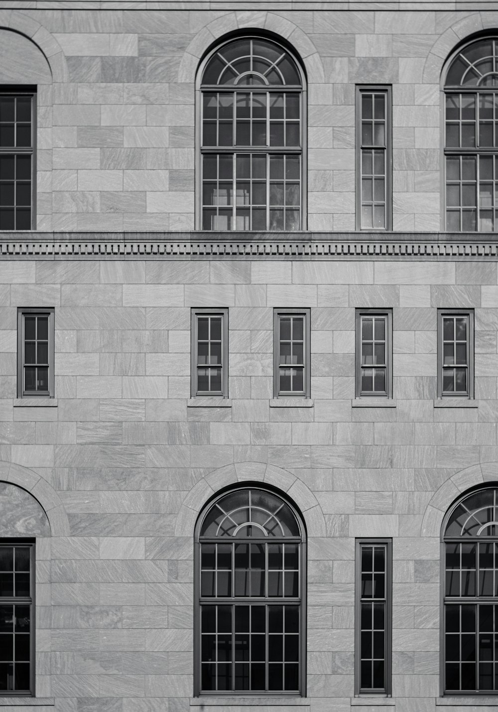 a black and white photo of a building with windows