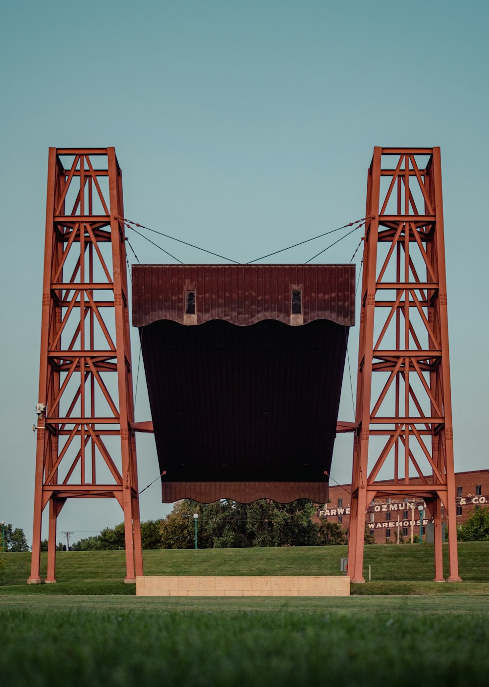 a large structure with a red roof in a field