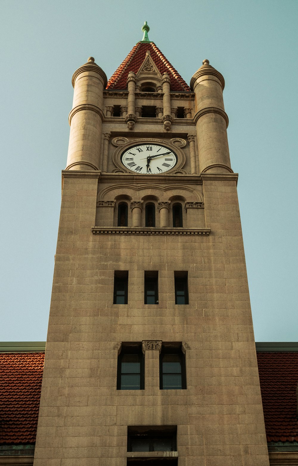 a tall clock tower with a clock on each of it's sides