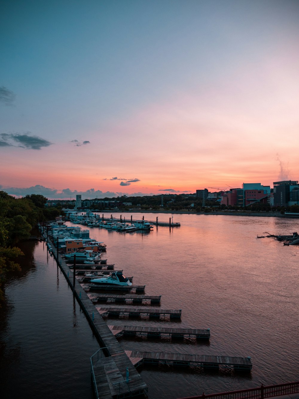 a harbor filled with lots of boats at sunset