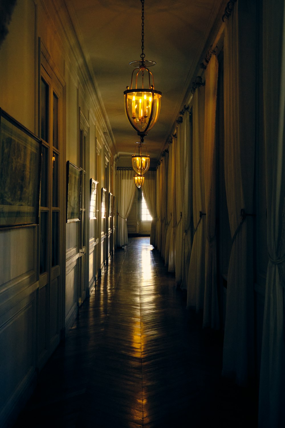 a long hallway with a light hanging from the ceiling