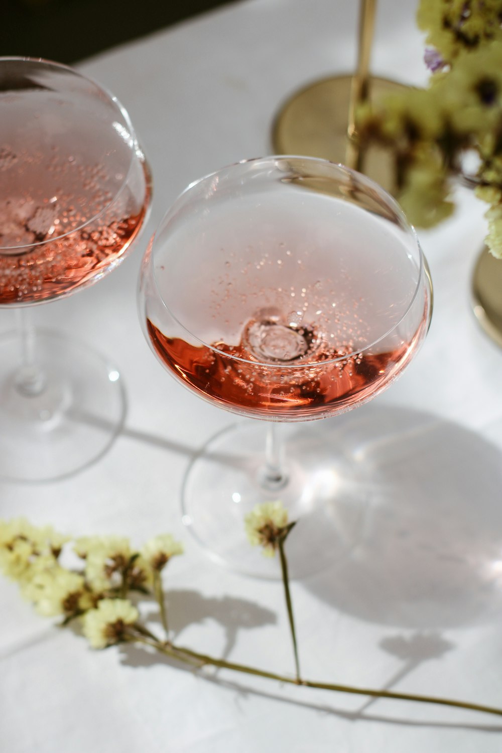 two glasses of wine sitting on a table