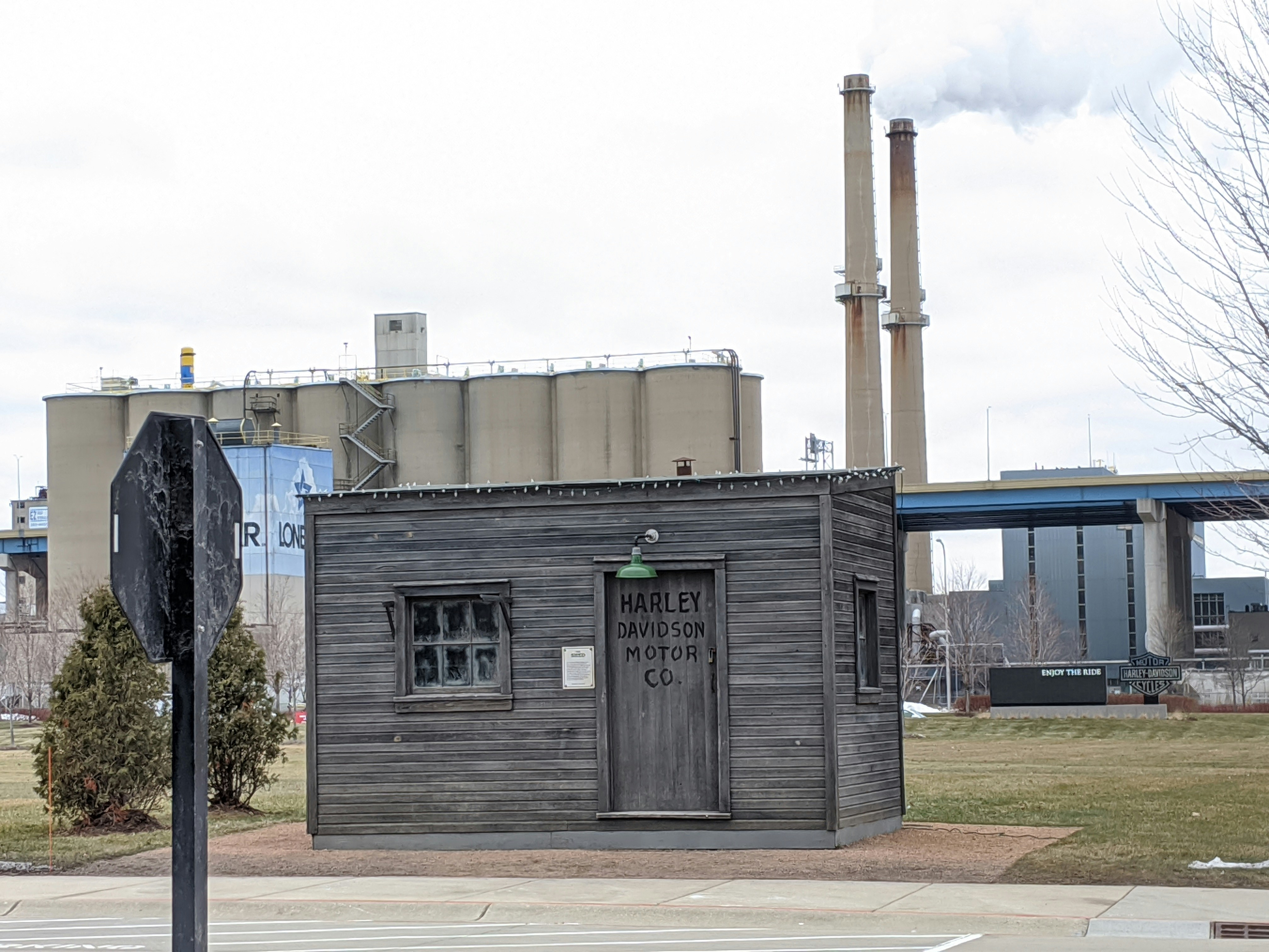 a wooden building with a sign in front of it