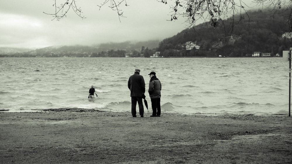 a couple of people that are standing in the water