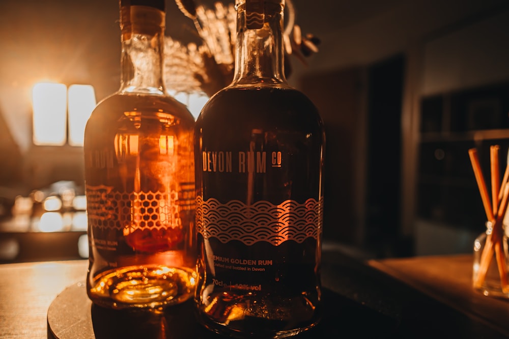 two bottles of liquor sitting on a table