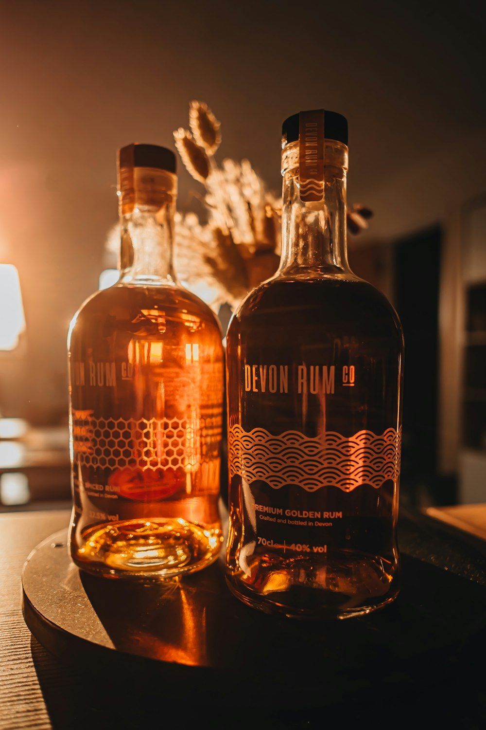 two bottles of alcohol sitting on a table