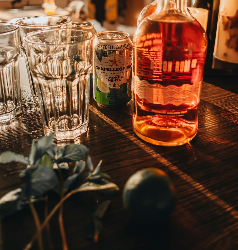 a bottle of alcohol sitting on top of a wooden table