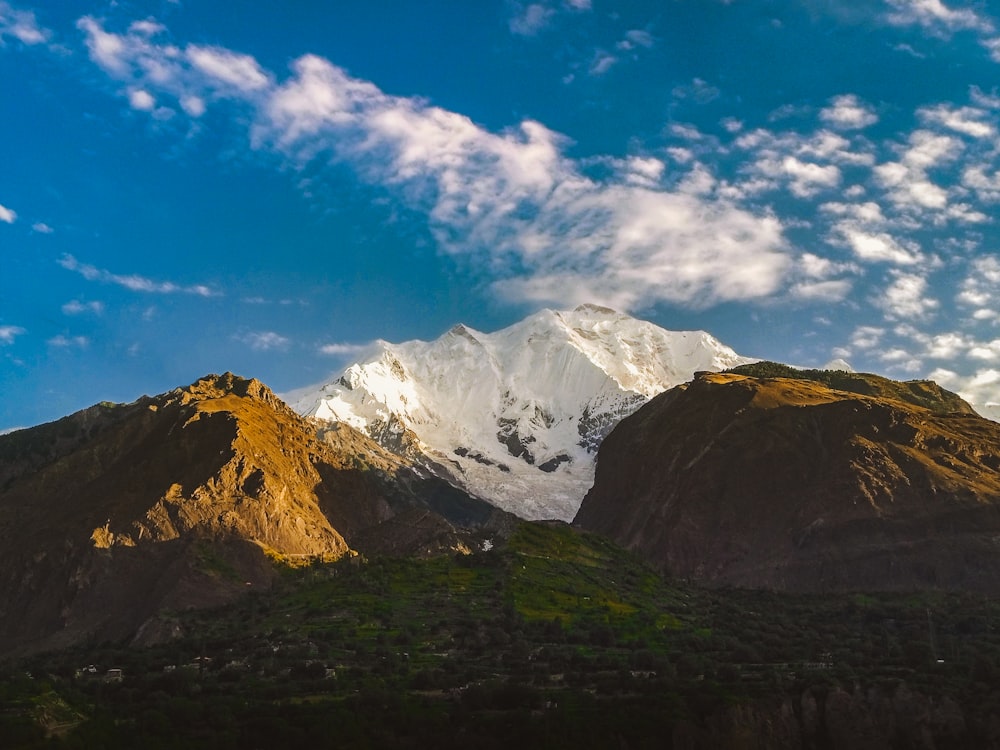 a snow covered mountain is seen in the distance