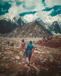 a couple of people that are walking in the dirt