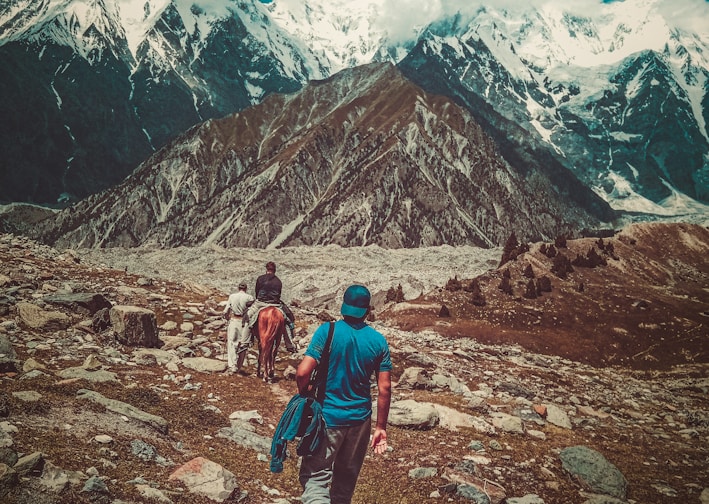 a couple of people that are walking in the dirt