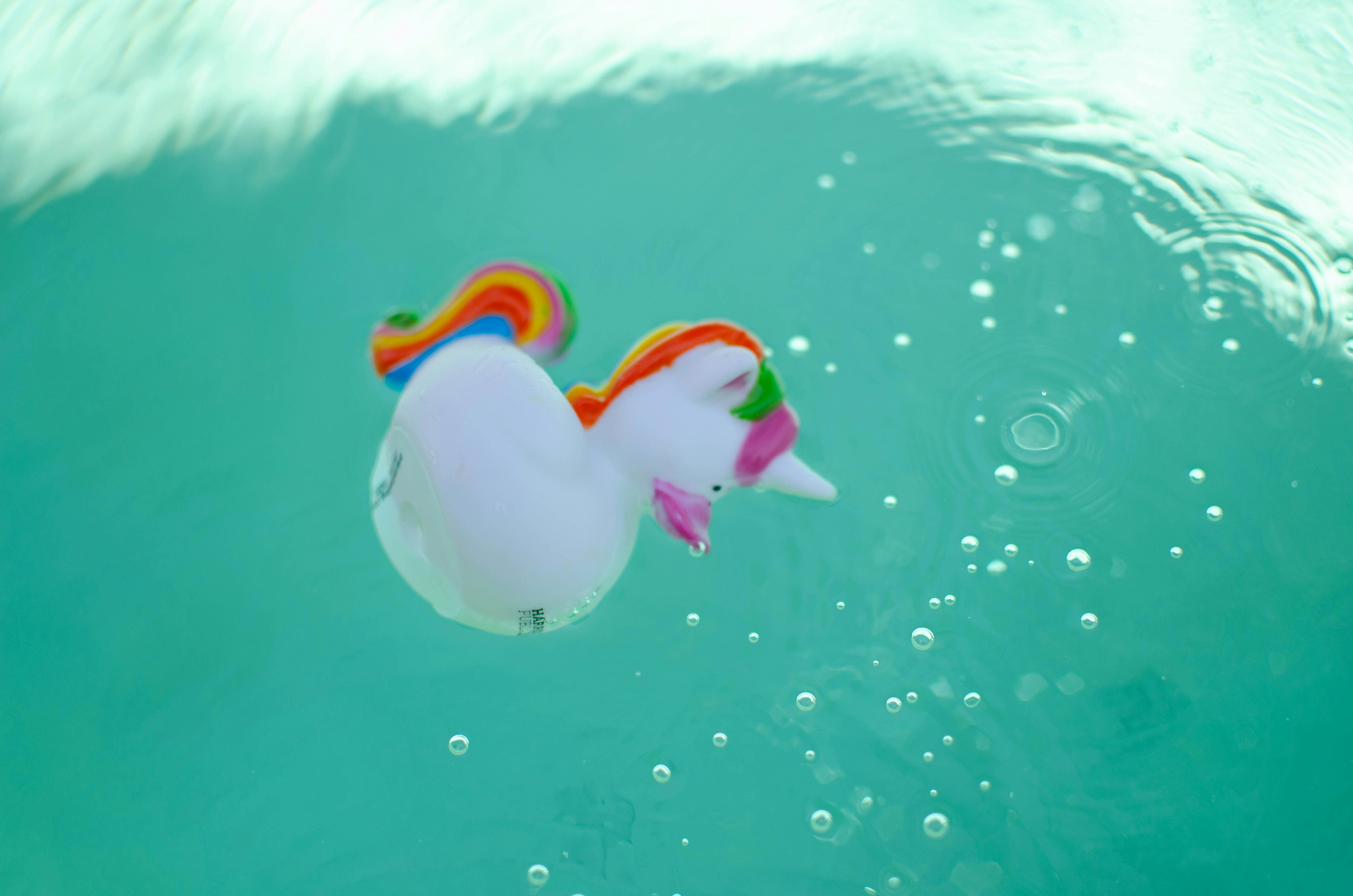 Soft unicorn plush toy in white and rainbow colors for children