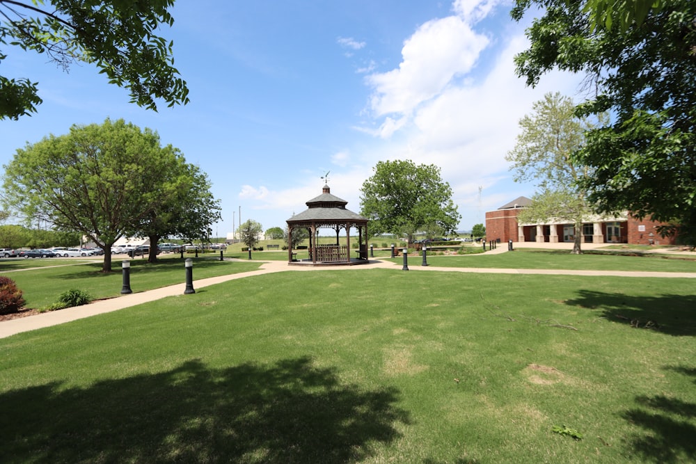 a gazebo in the middle of a grassy field