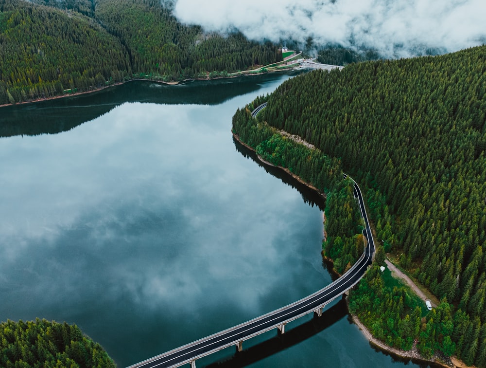 an aerial view of a bridge over a lake