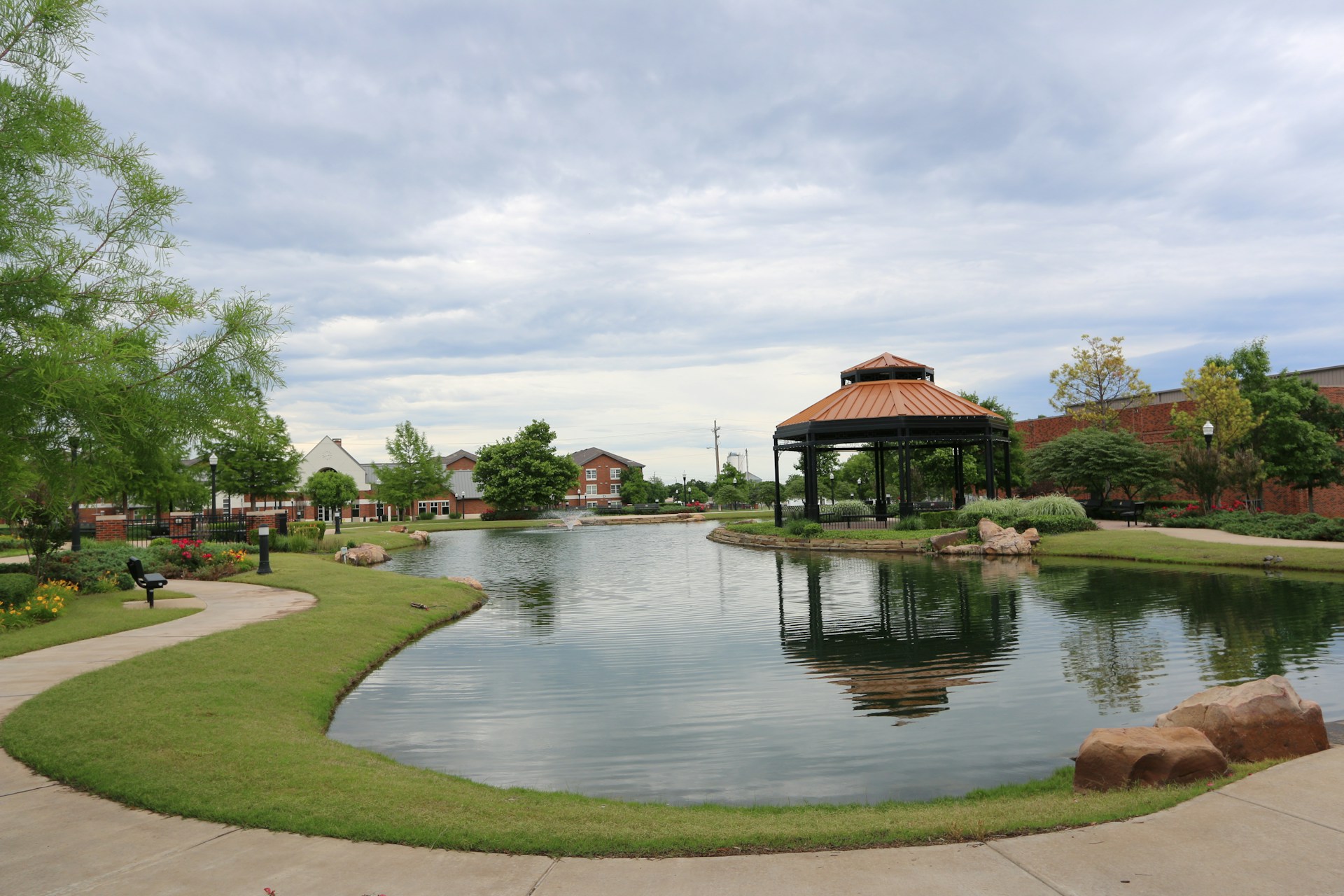 a pond with a gazebo in the middle of it