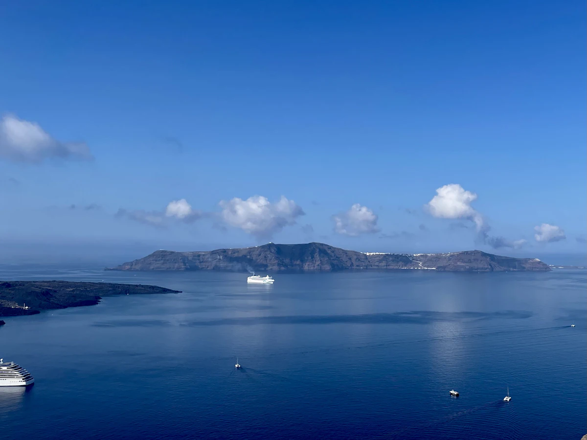 View of Santorini's volcanic caldera with the sea and cliffside terrain visible