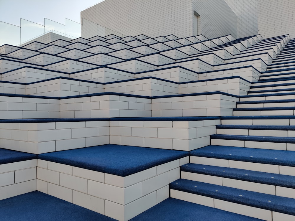 a set of blue and white stairs with blue carpet