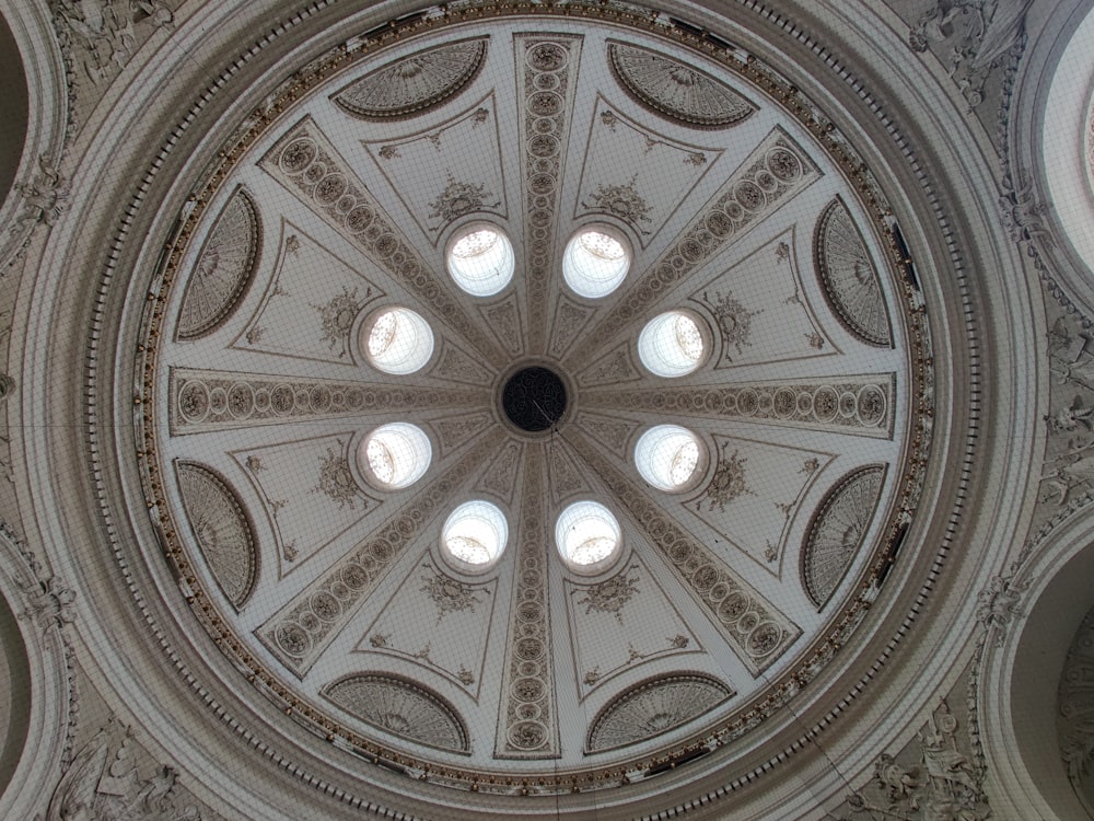 the ceiling of a large building with many windows