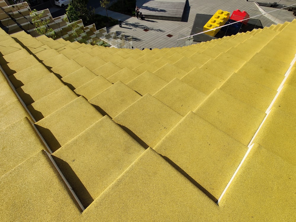 a close up of a yellow roof with a traffic light in the background