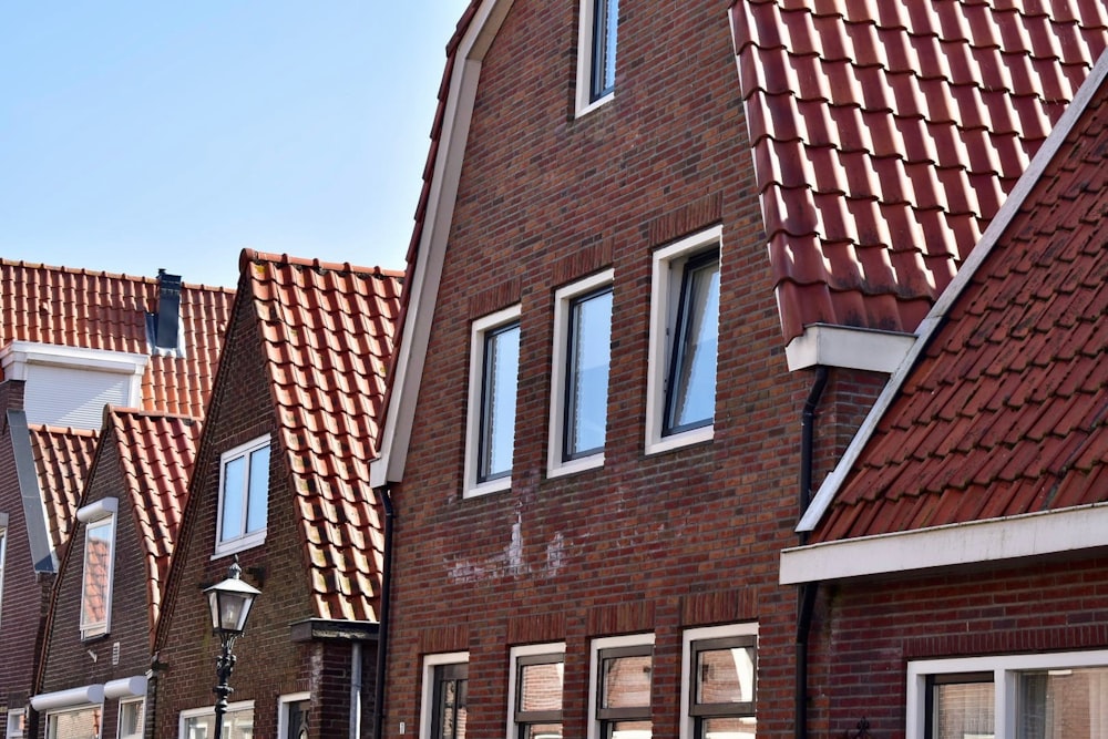 a row of red brick houses with white windows