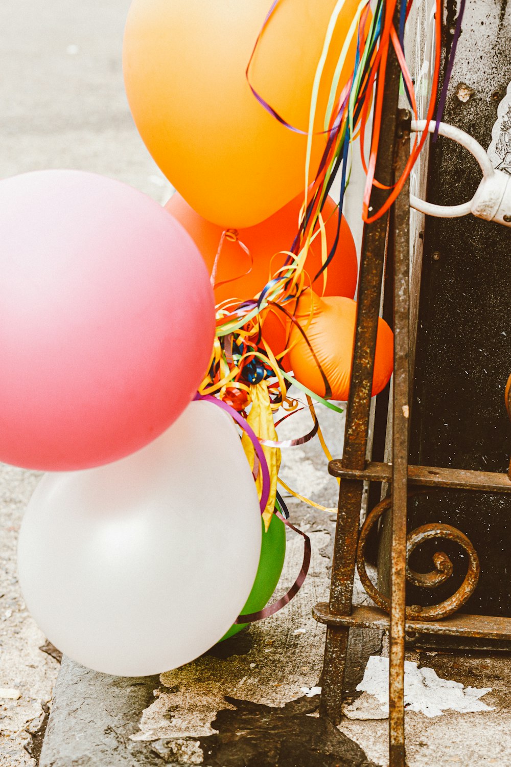 a bunch of balloons and streamers on the ground