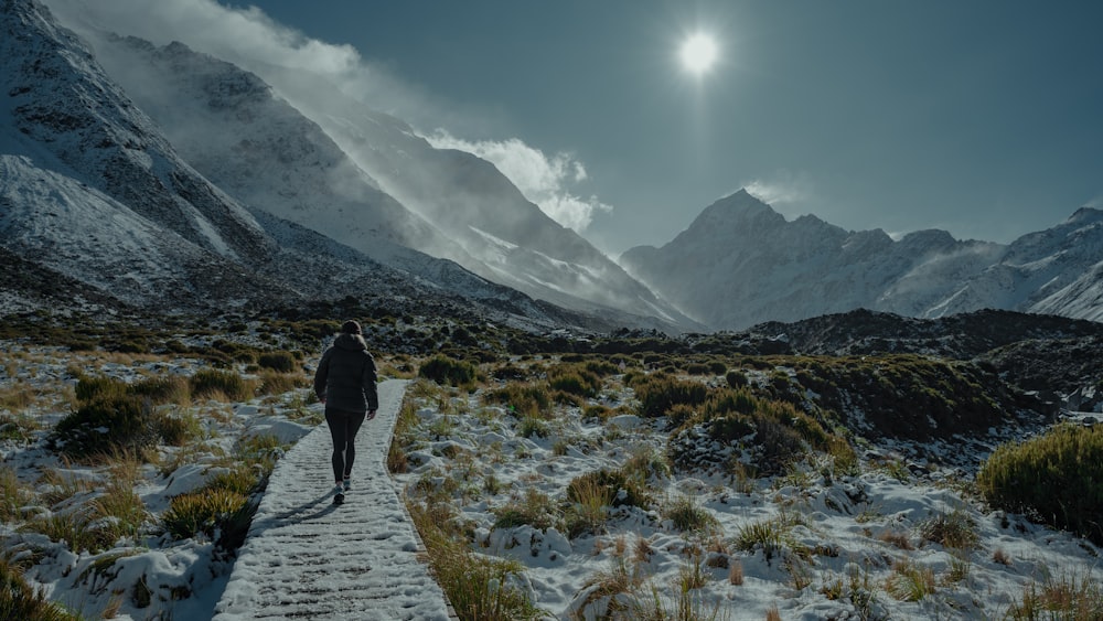 a person walking down a snow covered path