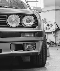 a black and white photo of a car in a garage