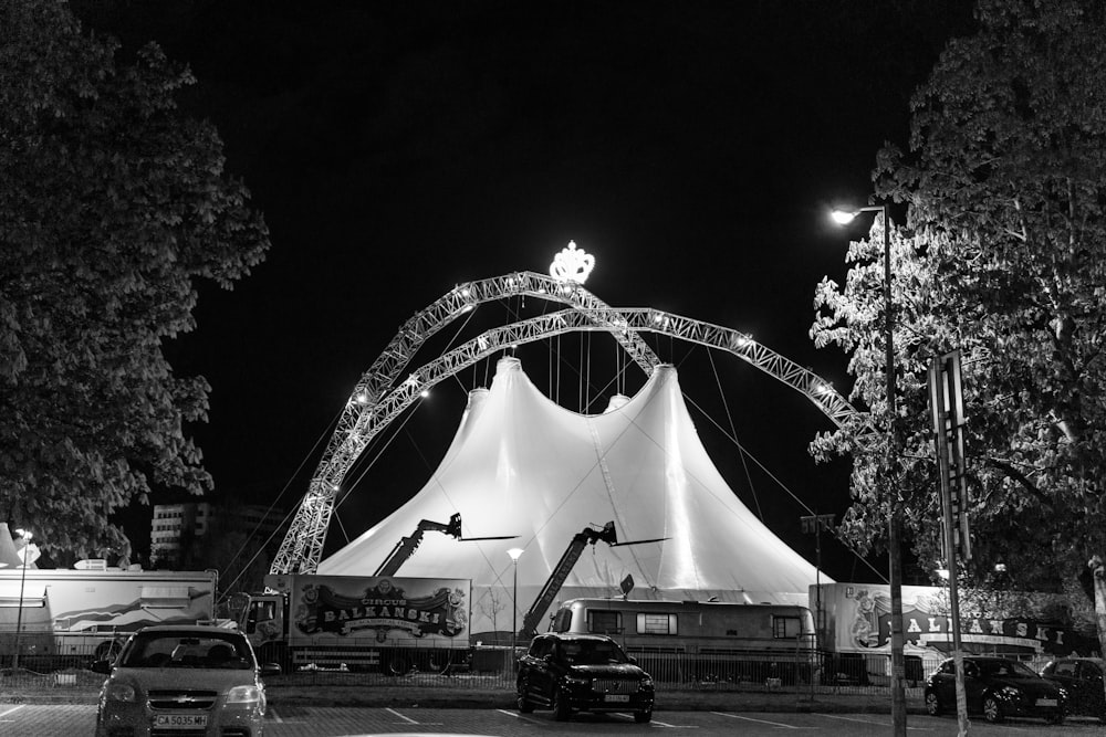 a large tent is lit up at night