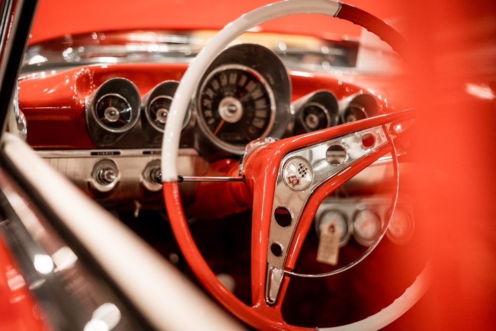 the interior of a classic car with a steering wheel and dashboard