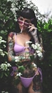 a woman in a bikini smoking a cigarette