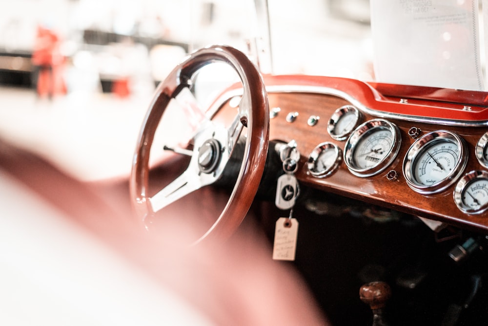 the dashboard of a classic car with gauges