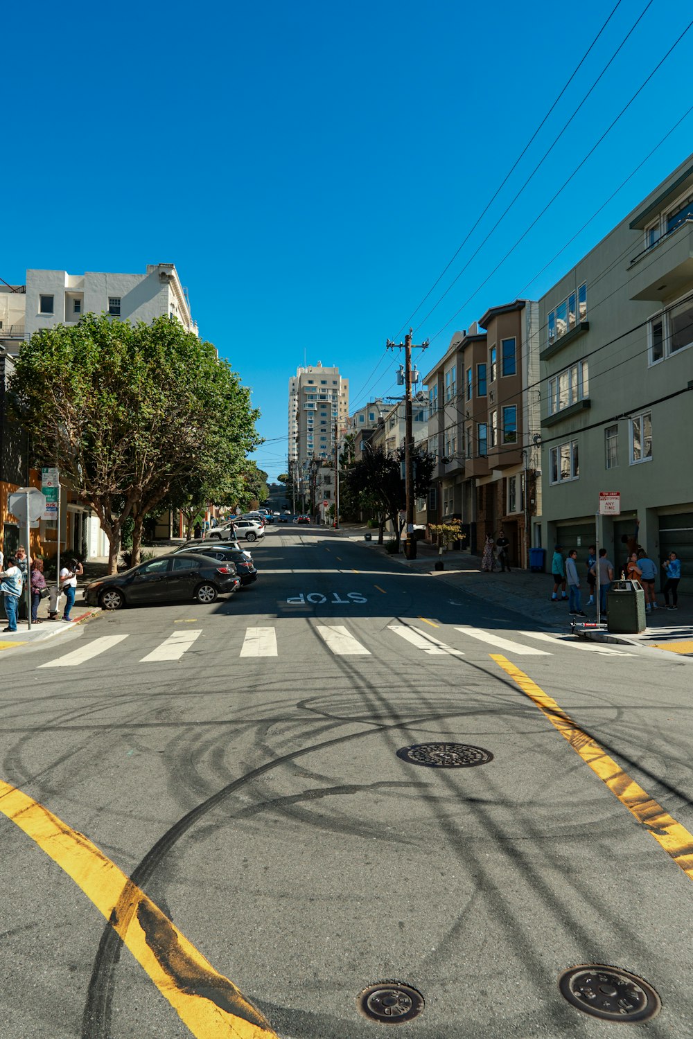 a city street with a yellow line painted on the road