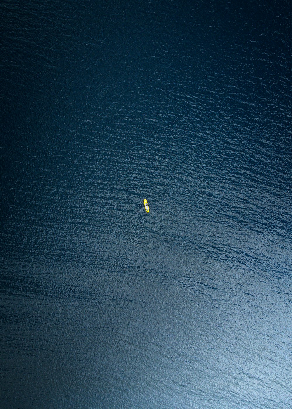 a yellow object floating in the middle of a body of water