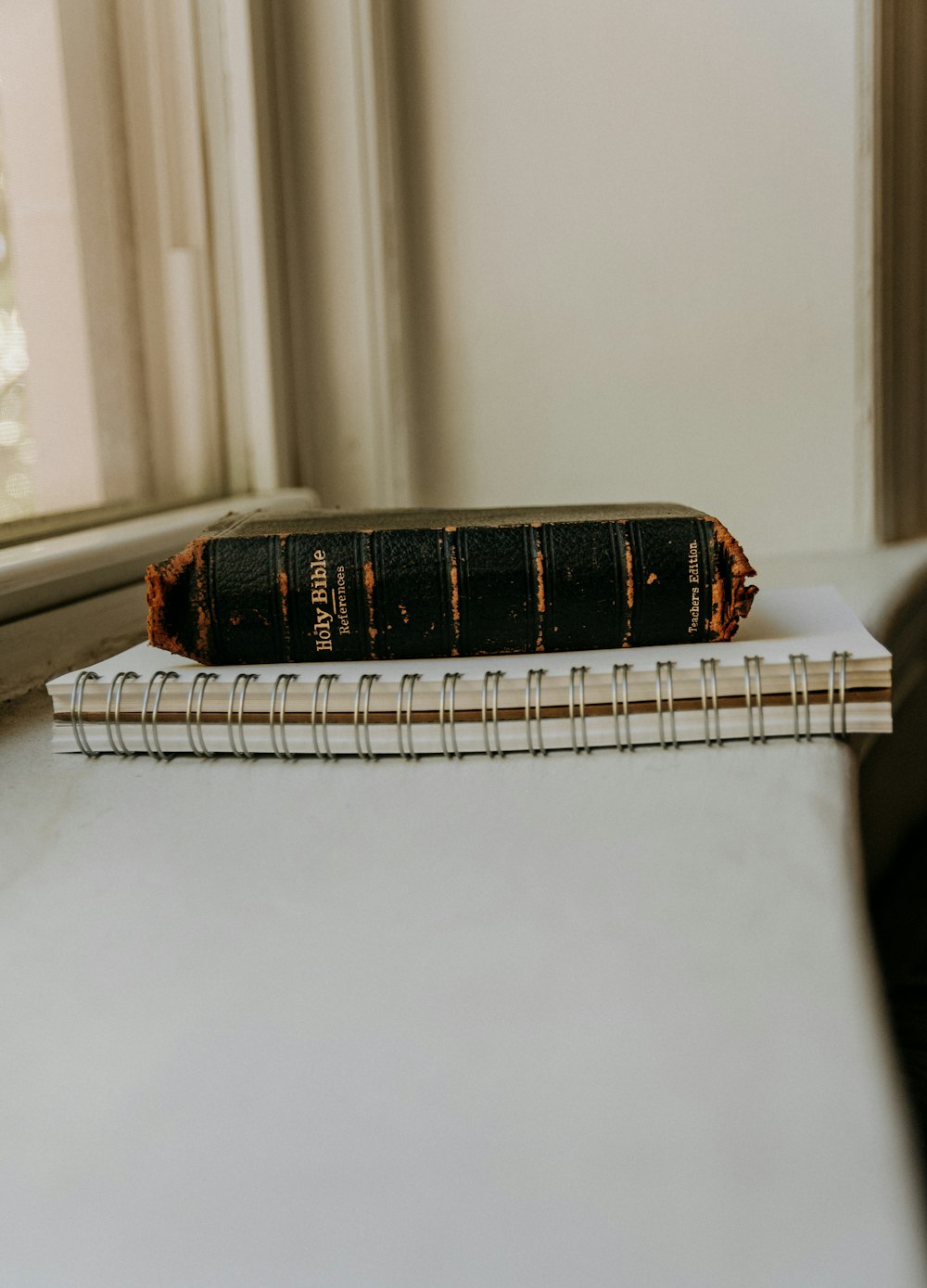 a book sitting on top of a table next to a window