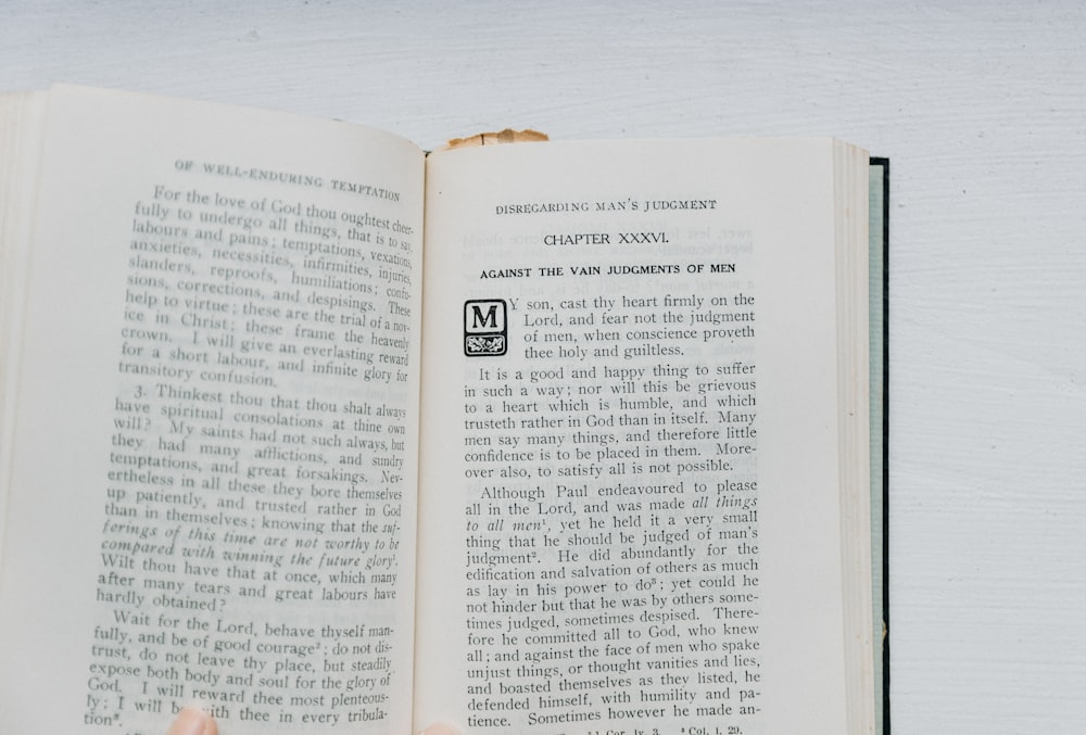 a person is holding a book open to read