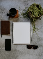 A stylish flat lay of a planner, smartphone, and a cup of tea, reflecting organized professional life.