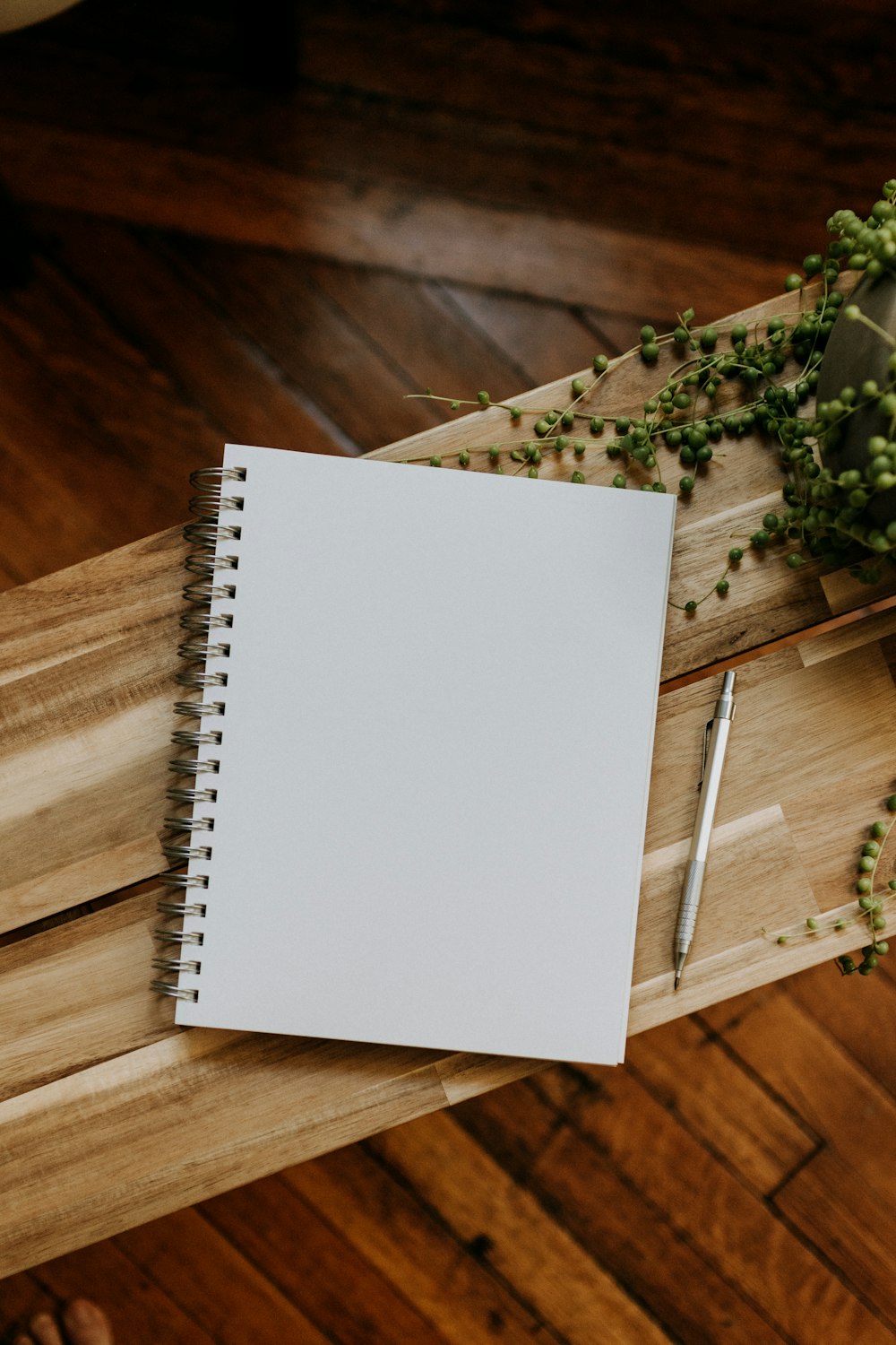 a notebook and pen on a wooden table