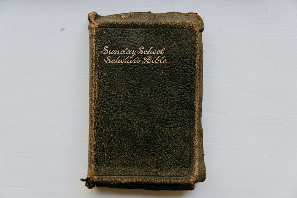 an old book sitting on top of a white table