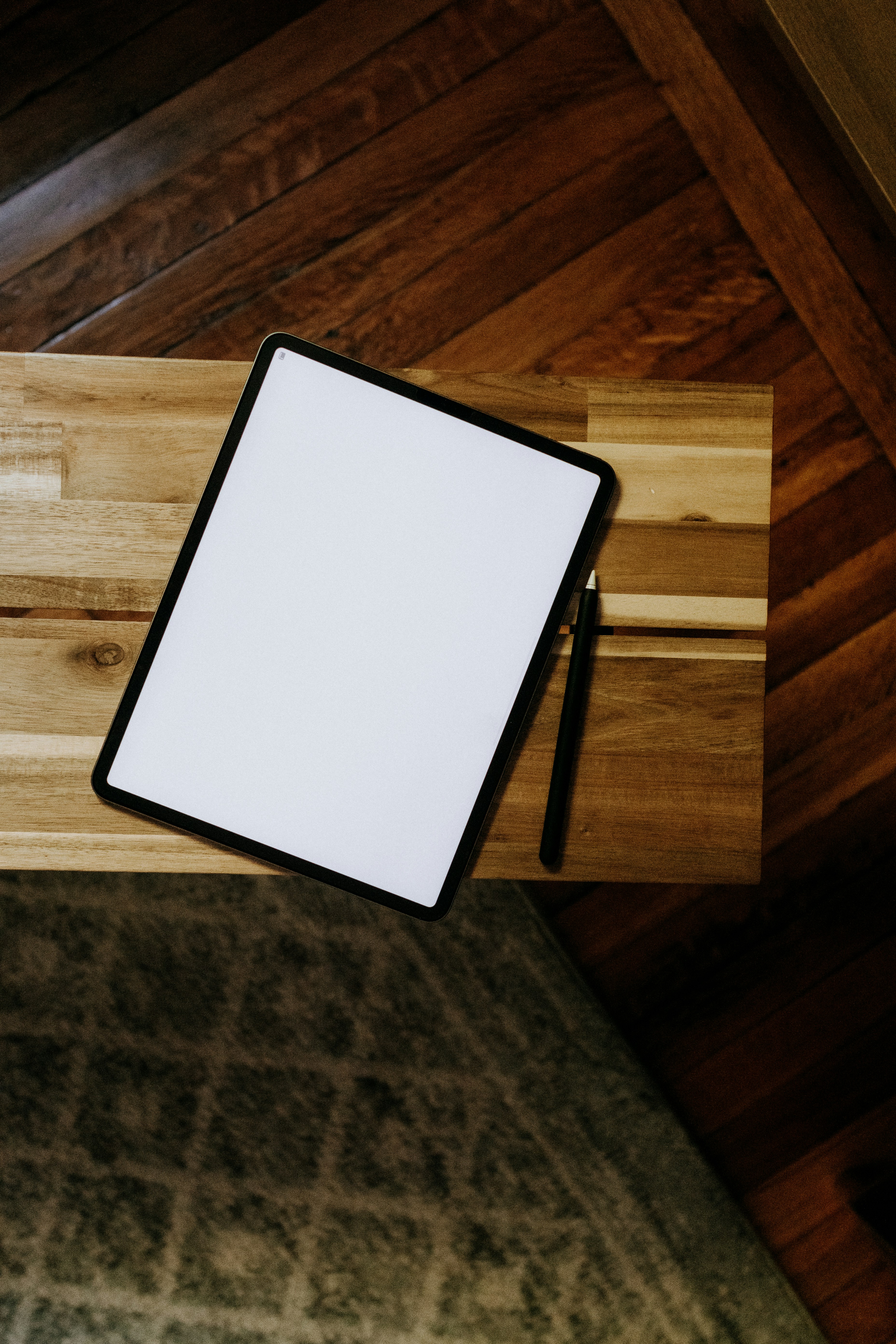 an overhead view of a bed with a wooden headboard